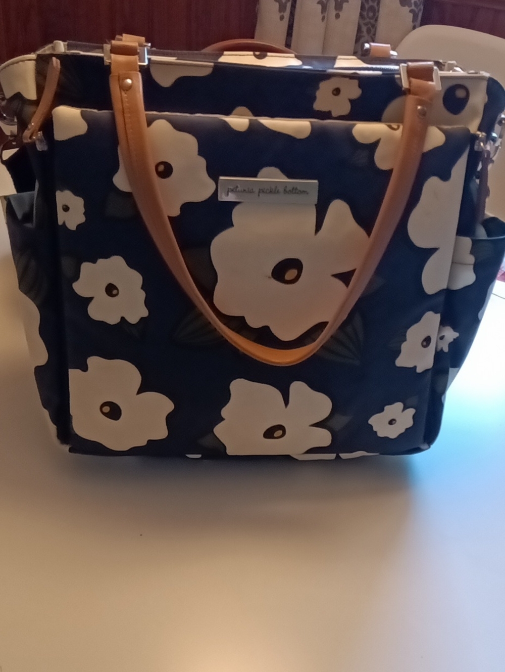 Petunia Pickle Bottom Navy Floral Diaper Bag with Cream Flowers and Tan Handles